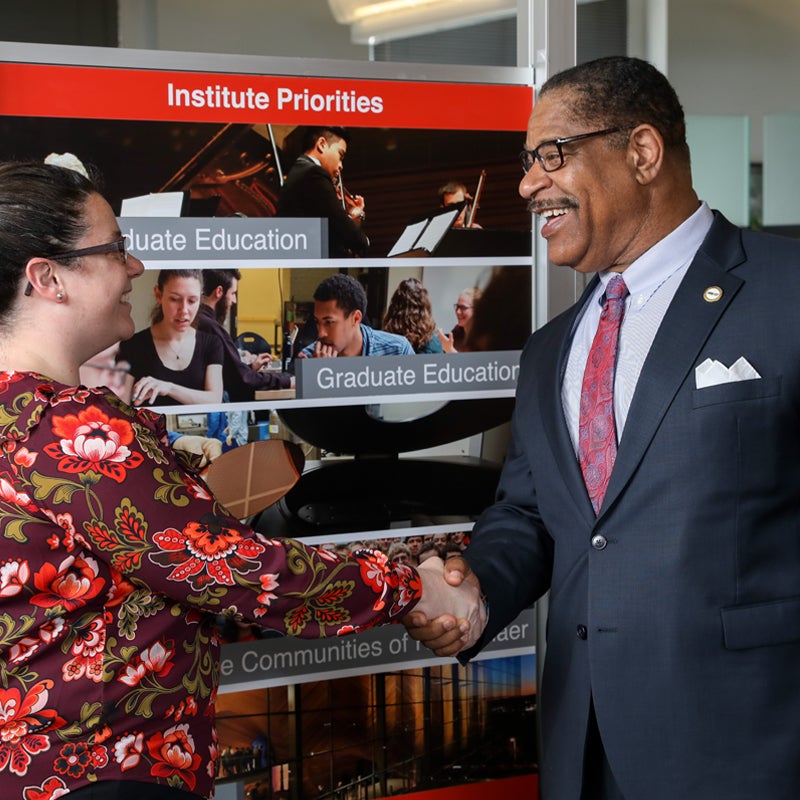 Man Shaking Hand of Women Welcoming Her to Rensselaer