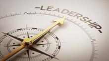 Compass pointing in the direction of the word leadership. 