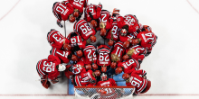Picture of a group of hockey players huddled on the ice